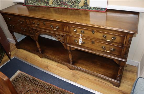 A reproduction oak low potboard dresser W.202cm